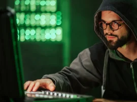 Ethical security professional testing systems from a laptop in a server room