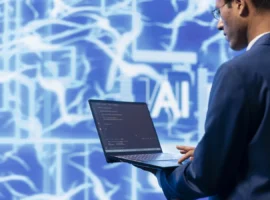 Cybersecurity analyst using a laptop in front of an artificial intelligence display